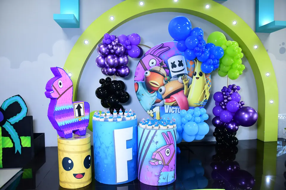 Mesa temática de Fortnite con globos morados y verdes
